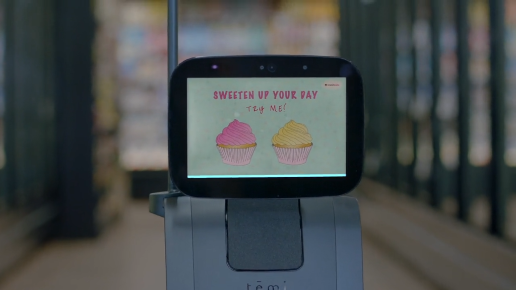 A temi robot offering free cupcakes with the text "Sweeten up your day - try me!"