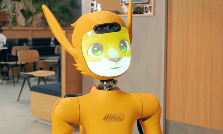 Close-up of the friendly Mirokaï companion robot, featuring its expressive fox-like face, large digital eyes, and wiggling sensory ears